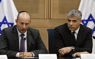 Yesh Atid chairman Yair Lapid (R) and Jewish Home head Naftali Bennett present an agreement reached between Israel's technological colleges and the Finance Ministry, at the Knesset, on October 27, 2013. (Flash90)