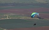 Illustrative: A paraglider flies over northern Israel on February 18, 2017. (Nati Shohat/Flash90)