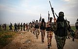 Fighters from the Islamic Jihad terror group march during a military drill near the border with Israel, east of the town of Khan Younis in the southern Gaza Strip, on March 27, 2018. (Abed Rahim Khatib/Flash90)