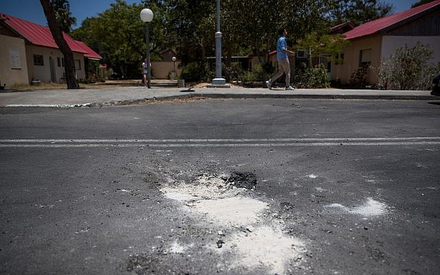 FILE -- A rocket fired from the Gaza Strip fell near houses at a kibbutz in southern Israel on June 20, 2018 (Yonatan Sindel/Flash90) FILE -- A rocket fired from the Gaza Strip fell near houses at a kibbutz in southern Israel on June 20, 2018 (Yonatan Sindel/Flash90)