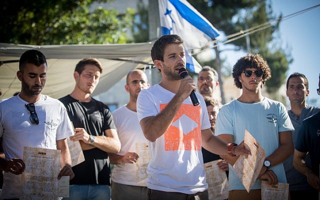 Tzur Goldin, the twin brother of slain and captured IDF soldier Hadar Goldin, speaks during a protest of IDF reserve soldiers who fought in the 2014 Gaza war, outside the Prime Minister's Residence, in Jerusalem, on July 8, 2018. (Yonatan Sindel/Flash90) Tzur Goldin, the twin brother of slain and captured IDF soldier Hadar Goldin, speaks during a protest of IDF reserve soldiers who fought in the 2014 Gaza war, outside the Prime Minister's Residence, in Jerusalem, on July 8, 2018. (Yonatan Sindel/Flash90)