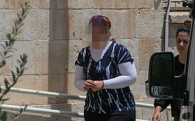 An ultra-Orthodox woman is brought to the Jerusalem Magistrate's Court, on July 3, 2018, under charges of abusing her children by injecting them with insulin to making false claims of diabetes for National Insurance money. (Yonatan Sindel/Flash90 )