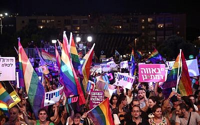 Members of the LGBT community and supporters participate in a protest against a Knesset bill amendment denying surrogacy for same-sex couples, at Rabin Square in Tel Aviv on July 22, 2018. (Miriam Alster/Flash90)