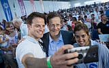 Illustrative: Jewish Agency head Isaac Herzog, center, at an event at Ben Gurion Airport to welcome some 300 new immigrants from France on a special flight organized by the Jewish Agency, July 23, 2018. (Miriam Alster/Flash90)