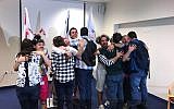 A group of Yazidis from Iraq (with their backs to the camera) together with Israeli trainers who gave them a course on medical clowning, June 2018. (Israel's Foreign Ministry)