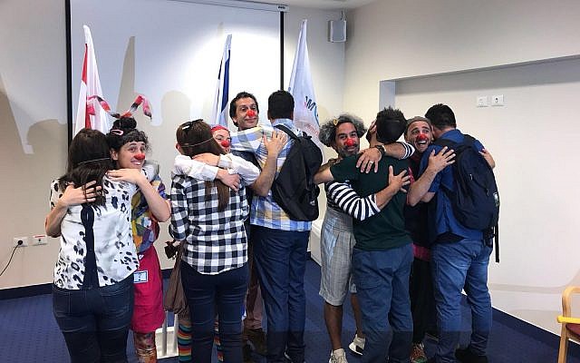 A group of Yazidis from Iraq (with their backs to the camera) together with Israeli trainers who gave them a course on medical clowning, June 2018. (Israel's Foreign Ministry) A group of Yazidis from Iraq (with their backs to the camera) together with Israeli trainers who gave them a course on medical clowning, June 2018. (Israel's Foreign Ministry)