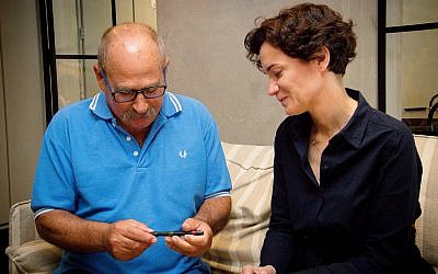 Yaron Roksa (left) receives pen that was confiscated from his father by the Nazis from ITS director Floriane Hohenberg, Jaffa, July 3, 2018. (Laura Ben-David/Courtesy of ITS)