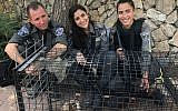 Border Police officers pose with a Eurasian eagle-owl that they rescued near Jerusalem, July 7, 2018 (Israel Police)