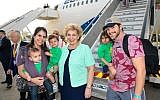 The Leopold family of Las Vegas meets Israel’s minister of aliyah and integration, Sofa Landver (c), after arriving on their aliyah charter flight with Nefesh B’Nefesh. (Shahar Azran)