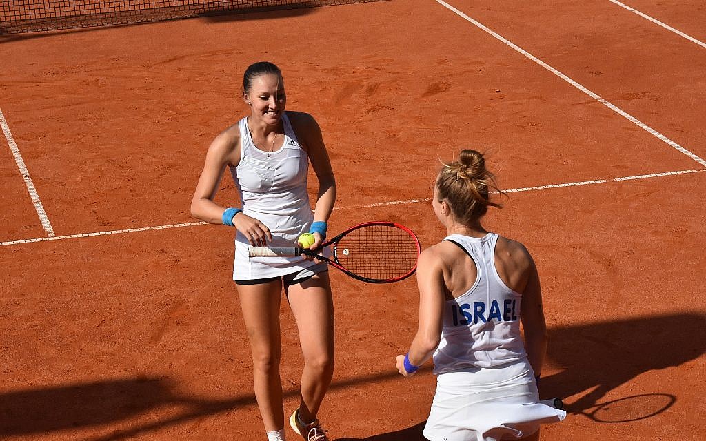 Julia Glushko, left, and Lina Glushko represent Israel playing doubles at the Fed Cup. (Ofra Friedman/ITA)
