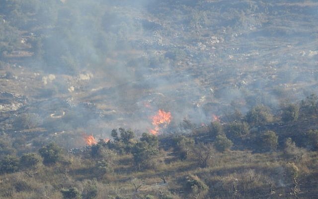 A fire is seen burning in the northern West Bank village of Burin on July 6, 2018. (Yesh Din) A fire is seen burning in the northern West Bank village of Burin on July 6, 2018. (Yesh Din)