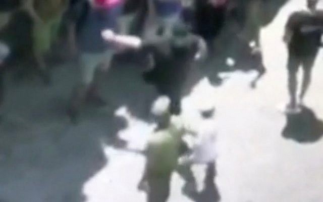 A screenshot from video of a Swiss member of the TIPH civilian monitoring group slapping a Jewish boy during a tour of the West Bank city of Hebron on June 11, 2018. (Screen capture: Hadashot TV news) A screenshot from video of a Swiss member of the TIPH civilian monitoring group slapping a Jewish boy during a tour of the West Bank city of Hebron on June 11, 2018. (Screen capture: Hadashot TV news)