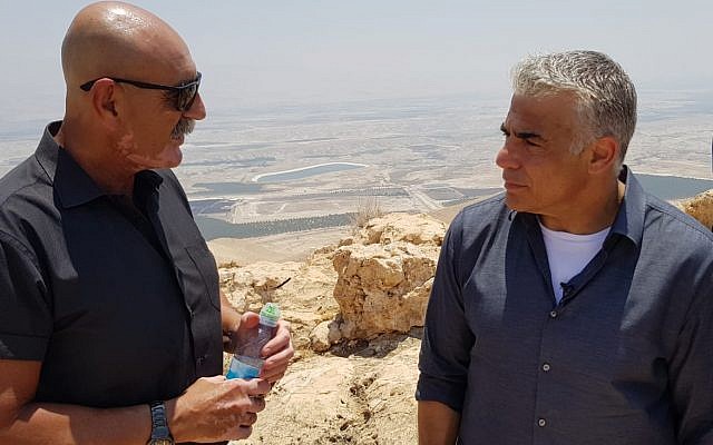 Jordan Valley Regional Council chairman David Elhayani (L) speaks to Yesh Atid chairman Yair Lapid at a lookout point above the Jordan Valley on July 23, 2018. (Courtesy) Jordan Valley Regional Council chairman David Elhayani (L) speaks to Yesh Atid chairman Yair Lapid at a lookout point above the Jordan Valley on July 23, 2018. (Courtesy)