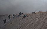 Israeli soldiers perched in defensive positions on an embankment near the Gaza border during a violent Palestinian protest, July 27, 2018 (Courtesy IDF)