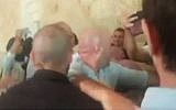 A brawl between families of slain Palestinian terrorists and those of Israeli victims at the Supreme Court in Jerusalem on July 17, 2018 (Hadashot TV screenshot)