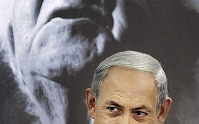 Prime Minister Benjamin Netanyahu chairs a cabinet meeting at Kibbutz Sde Boker, Israel, Sunday, Nov. 10, 2013. A portrait of the first Israeli prime minister David Ben Gurion is seen at background. (AP Photo/David Buimovitch, Pool)