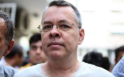 In this file photo taken on July 25, 2018, US pastor Andrew Craig Brunson is escorted by Turkish plainclothes police officers to his house on in Izmir. (AFP Photo)