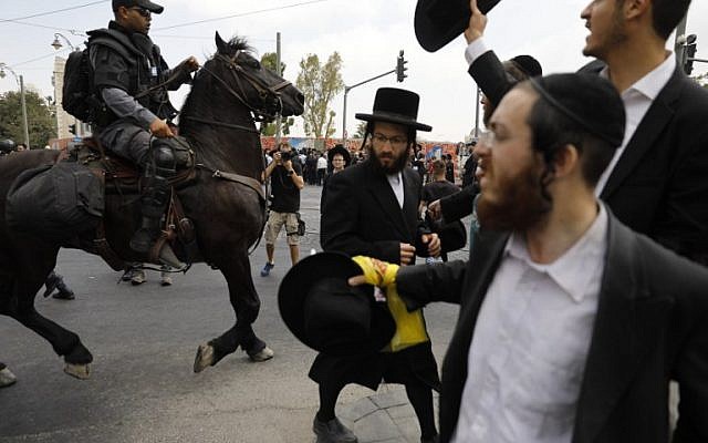 A member of the Israeli mounted police unit tries to disperse a demonstration of ultra-Orthodox protesting against the arrest of a draft dodger in Jerusalem on August 2, 2018. (AFP PHOTO / Menahem KAHANA) A member of the Israeli mounted police unit tries to disperse a demonstration of ultra-Orthodox protesting against the arrest of a draft dodger in Jerusalem on August 2, 2018. (AFP PHOTO / Menahem KAHANA)