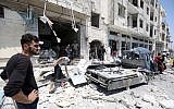 Syrians gather at a site of car bomb in the northwestern Syrian city of Idlib on August 2, 2018.  (AFP PHOTO / OMAR HAJ KADOUR)