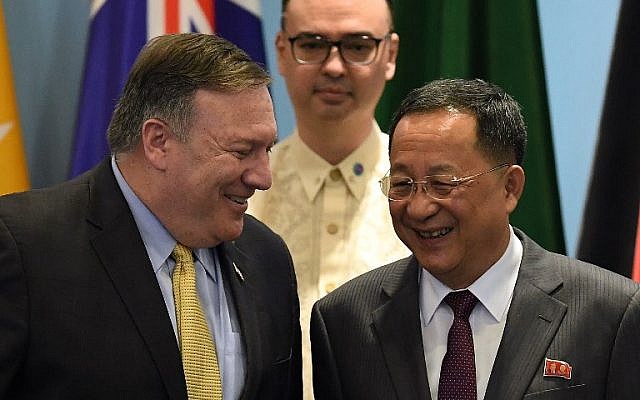US Secretary of State Mike Pompeo (L) chats with North Korea's Foreign Minister Ri Yong Ho (R) as Philippine Foreign Secretary Alan Peter Cayetano (behind) looks on, as they arrive for a group photo at the ASEAN Regional Forum Retreat during the 51st Association of Southeast Asian Nations (ASEAN) Ministerial Meeting (AMM) in Singapore on August 4, 2018. (AFP PHOTO / MOHD RASFAN US Secretary of State Mike Pompeo (L) chats with North Korea's Foreign Minister Ri Yong Ho (R) as Philippine Foreign Secretary Alan Peter Cayetano (behind) looks on, as they arrive for a group photo at the ASEAN Regional Forum Retreat during the 51st Association of Southeast Asian Nations (ASEAN) Ministerial Meeting (AMM) in Singapore on August 4, 2018. (AFP PHOTO / MOHD RASFAN