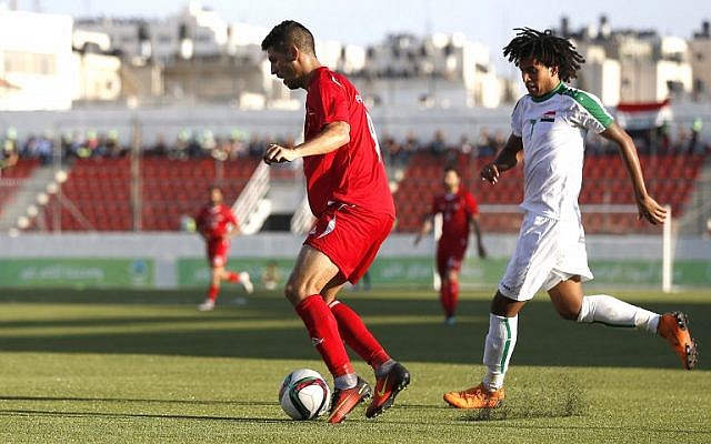 File: Palestinian Tamer Syam, left and Iraqi Mazin Fyad vie for the ball during the friendly soccer match between the Palestinian and Iraqi national teams at the Faisal al-Husseini stadium in the West Bank town of al-Ram on August 4, 2018. (AFP/Abbas Momani)