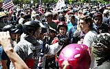 An alt-right sympathizer, left, knocks the hat off an opponent's head as alt-right activists, anti-fascist protesters, and people on all sides of the political spectrum gather for a campaign rally organized by right-wing organizer, Patriot Prayer founder and Republican Senate candidate Joey Gibson in Portland, Oregon, August 4, 2018.
(AFP/Thomas Patterson)