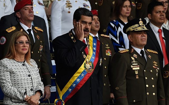 Venezuelan President Nicolas Maduro (C) gestures next to his wife Cilia Flores (L) during a ceremony to celebrate the 81st anniversary of the National Guard in Caracas on August 4, 2018. (AFP/ Juan BARRETO) Venezuelan President Nicolas Maduro (C) gestures next to his wife Cilia Flores (L) during a ceremony to celebrate the 81st anniversary of the National Guard in Caracas on August 4, 2018. (AFP/ Juan BARRETO)