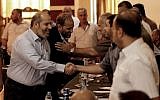 Hamas officials Husam Badran (2nd-L) and Khalil al-Hayya (L) arrive for a meeting with Palestinian factions in Gaza City on August 5, 2018. (AFP Photo/Mahmud Hams)