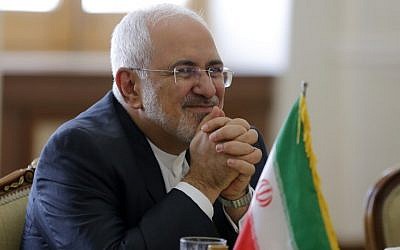 Iran's Foreign Minister Mohammad Javad Zarif smiles while meeting with North Korea's Foreign Minister Ri Yong Ho in the capital Tehran on August 7, 2018. (AFP Photo/Atta Kenare)