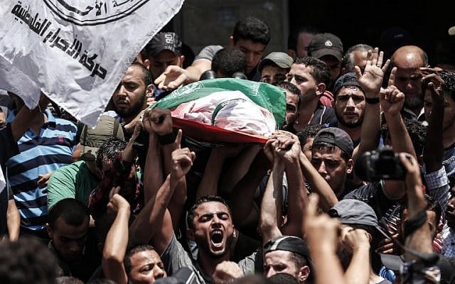 Palestinian mourners carry the body of a Hamas sniper killed by Israeli fire, during his funeral in Jabalia, in the northern Gaza Strip, on August 7, 2018. (AFP/MAHMUD HAMS) Palestinian mourners carry the body of a Hamas sniper killed by Israeli fire, during his funeral in Jabalia, in the northern Gaza Strip, on August 7, 2018. (AFP/MAHMUD HAMS)