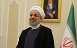 Iranian President Hassan Rouhani smiles during a meeting with the North Korean foreign minister in the capital Tehran on August 8, 2018. (AFP/Atta Kenare)