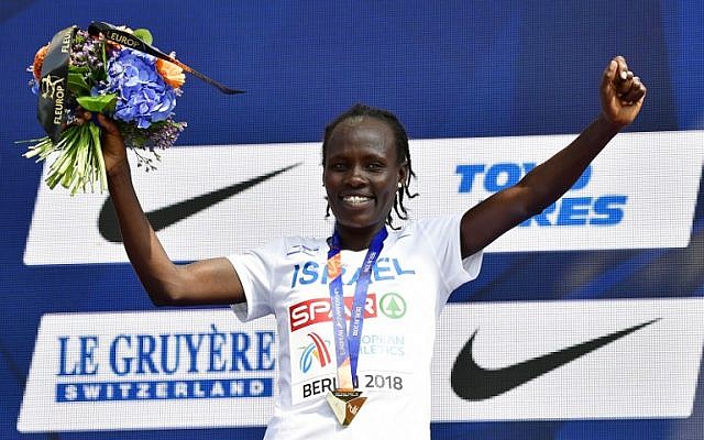 Winner Israel's Lonah Chemtai Salpeter celebrates on the podium with her medal during the medal ceremony of the women's 10000m event during the European Athletics Championships in Berlin on August 9, 2018. (AFP PHOTO / Tobias SCHWARZ) Winner Israel's Lonah Chemtai Salpeter celebrates on the podium with her medal during the medal ceremony of the women's 10000m event during the European Athletics Championships in Berlin on August 9, 2018. (AFP PHOTO / Tobias SCHWARZ)