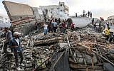 A picture taken on August 9, 2018, shows people inspecting the rubble of a building targeted by the Israeli Air Force in response to a rocket attack that hit southern Israel earlier in the day on August 9, 2018. (AFP Photo/Mahmud Hams)
