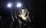 A child is recovered from the rubble of a building following Syrian government forces air strikes in the rebel town of Orum al-Kubra in the northern province of Aleppo late on August 10, 2018. (AFP PHOTO / Amer ALHAMWE)