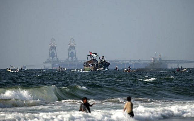 Palestinian boats participate in a protest against the Israeli-Egyptian security blockade of Gaza, in Beit Lahya on the border with Israel in the northern Gaza strip on August 11, 2018. The Israeli Rutenberg power station can be seen in the background. (AFP PHOTO / MAHMUD HAMS) Palestinian boats participate in a protest against the Israeli-Egyptian security blockade of Gaza, in Beit Lahya on the border with Israel in the northern Gaza strip on August 11, 2018. The Israeli Rutenberg power station can be seen in the background. (AFP PHOTO / MAHMUD HAMS)