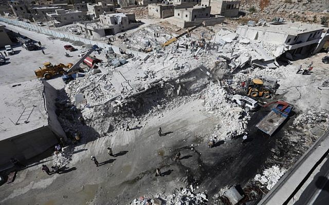 Destroyed buildings are seen on August 12, 2018, following an explosion at an arms depot in a residential area in Syria's northern Idlib province city of Sarmada in which 12 people were reportedly killed. (AFP PHOTO / OMAR HAJ KADOUR) Destroyed buildings are seen on August 12, 2018, following an explosion at an arms depot in a residential area in Syria's northern Idlib province city of Sarmada in which 12 people were reportedly killed. (AFP PHOTO / OMAR HAJ KADOUR)