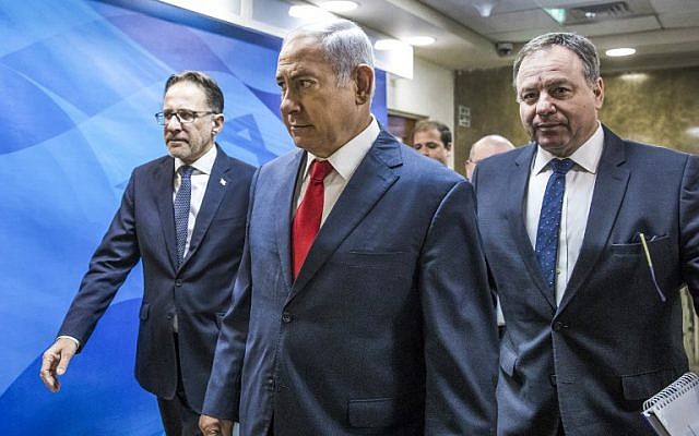 Prime Minister Benjamin Netanyahu, center, arrives ahead of the weekly cabinet meeting at his office in Jerusalem, August 12, 2018. (Jim Hollander/AFP) Prime Minister Benjamin Netanyahu, center, arrives ahead of the weekly cabinet meeting at his office in Jerusalem, August 12, 2018. (Jim Hollander/AFP)