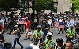 Police escort far-right demonstrators during a rally at Lafayette Park opposite the White House, on August 12, 2018, in Washington, DC, one year after the deadly violence at a similar protest in Charlottesville, Virginia. (AFP / Nicholas Kamm)