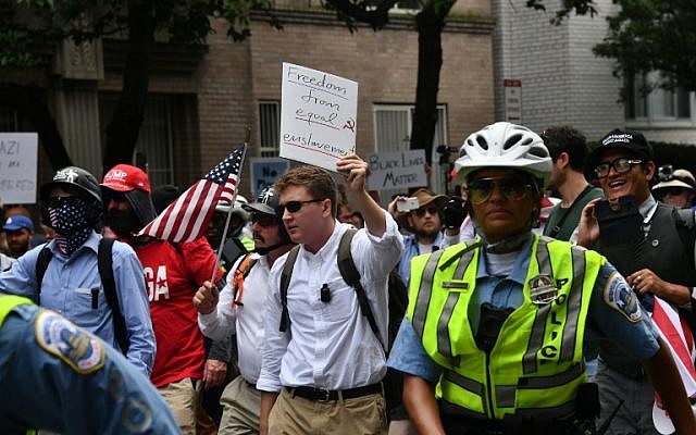 Police escort far-right demonstrators during a rally at Lafayette Park opposite the White House August 12, 2018 in Washington, DC, one year after the deadly violence at a similar protest in Charlottesville, Virginia. (AFP/ Nicholas Kamm) Police escort far-right demonstrators during a rally at Lafayette Park opposite the White House August 12, 2018 in Washington, DC, one year after the deadly violence at a similar protest in Charlottesville, Virginia. (AFP/ Nicholas Kamm)