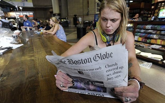 Lauren Vowells, 29, of Boston, Massachusetts, reads a copy of the Boston Globe at South Station in Boston, August 15, 2018. (AFP PHOTO / Joseph PREZIOSO) Lauren Vowells, 29, of Boston, Massachusetts, reads a copy of the Boston Globe at South Station in Boston, August 15, 2018. (AFP PHOTO / Joseph PREZIOSO)