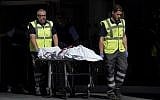The body of a man who tried to attack a police station is carried out of the premises in Cornella near the northeastern Spanish city of Barcelona on August 20, 2018. (LLUIS GENE/AFP)