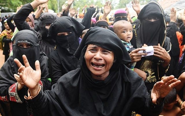 Rohingya refugees cry and shout slogans during a protest march following a ceremony to remember the first anniversary of a military crackdown that prompted a massive exodus of people from Myanmar to Bangladesh, at the Kutupalong refugee camp in Ukhia, on August 25, 2018. (AFP Photo/Dibyangshu Sarkar) Rohingya refugees cry and shout slogans during a protest march following a ceremony to remember the first anniversary of a military crackdown that prompted a massive exodus of people from Myanmar to Bangladesh, at the Kutupalong refugee camp in Ukhia, on August 25, 2018. (AFP Photo/Dibyangshu Sarkar)