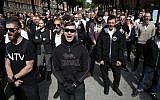 Supporters of the neo-Nazi Nordic Resistance Movement chant slogans during a demonstration at the Kungsholmstorg square in Stockholm, Sweden on August 25, 2018. (AFP/ TT News Agency / Fredrik Persson)