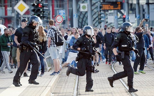 Riot police cross the street as a city festival is cancelled on August 26, 2018 in Chemnitz, eastern Germany, after a 35-year-old German national dies in hospital following a 'dispute between several people of different nationalities,' according to the police. (AFP Photo/dpa/Andreas Seidel) Riot police cross the street as a city festival is cancelled on August 26, 2018 in Chemnitz, eastern Germany, after a 35-year-old German national dies in hospital following a 'dispute between several people of different nationalities,' according to the police. (AFP Photo/dpa/Andreas Seidel)