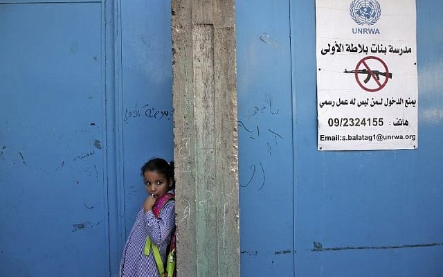 A pupil stands at the entrance of a school run by United Nations Agency for Palestinian Refugees in Balata refugee camp, east of the West Bank city of Nablus, on August 29, 2018, on the first day of classes after the summer holidays. (AFP Photo/Jaafar Ashtiyeh) A pupil stands at the entrance of a school run by United Nations Agency for Palestinian Refugees in Balata refugee camp, east of the West Bank city of Nablus, on August 29, 2018, on the first day of classes after the summer holidays. (AFP Photo/Jaafar Ashtiyeh)