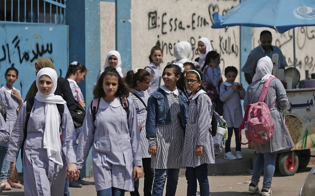 Illustrative: Pupils gather in front of a school run by the United Nations Agency for Palestinian Refugees (UNRWA) in Gaza City on August 29, 2018, on the first day of classes after the summer holidays. (AFP PHOTO / Mahmud Hams)