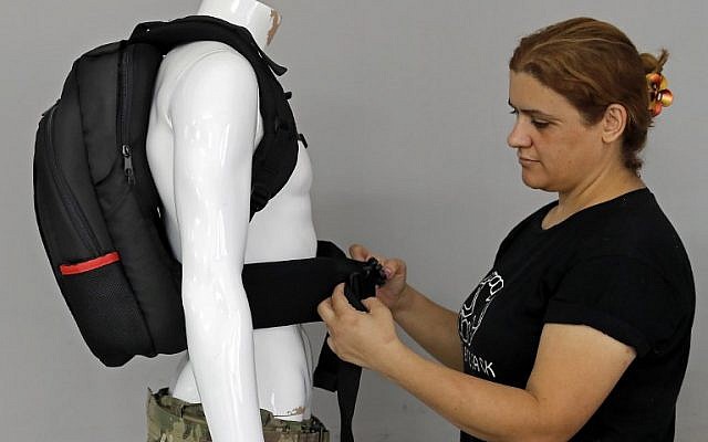 An employee of the Israeli protection gear manufacturer Masada Armour adjusts a new civilian bulletproof backpack, designed for college students, at the company's headquarters in Julis, in northern Israel, on August 30, 2018. (AFP Photo/Ahmad Gharabli) An employee of the Israeli protection gear manufacturer Masada Armour adjusts a new civilian bulletproof backpack, designed for college students, at the company's headquarters in Julis, in northern Israel, on August 30, 2018. (AFP Photo/Ahmad Gharabli)