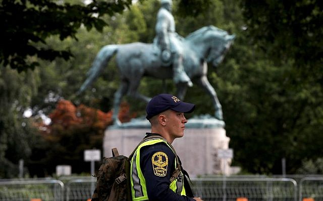 A member of the Virginia State Police waits outside the park where a statue of Confederate Gen. Robert E. Lee is located August 11, 2018 in Charlottesville, Virginia. 
 (Win McNamee/Getty Images/AFP)