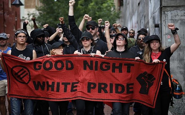 A group of protesters known as "Antifa", or anti-fascists, march near the site of a makeshift memorial where Heather Heyer was killed at a neo-Nazi rally last year on August 11, 2018 in Charlottesville, Virginia. (Win McNamee/Getty Images/AFP)