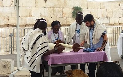 Members of the Ugandan-Jewish Abuyudaya community in Israel on a Birthright trip organized by MAROM participate in a ceremony celebrating the dedication of a new Torah scroll at the Western Wall's egalitarian prayer pavilion, August 27, 2018. (Courtesy MAROM)